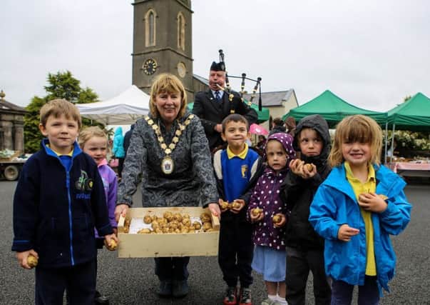 Pupils from Alexander Dickson Primary School from Ballygowan carried in the first crop of Comber Earlies to the Comber Farmers' Market. They were accompanied by Alderman Deborah Girvan, Mayor of Ards and North Down and Glen Cupples, a piper from the Cleland Pipe Band. The pupils from Alexander Dickson Primary School have been involved in the Potty Potato competition