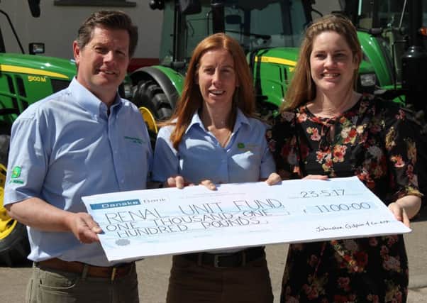 Randal and Suzanne McConnell present a cheque for Â£1,100 to Dr Jennifer Hanko, Renal Consultant at Belfast City Hospital