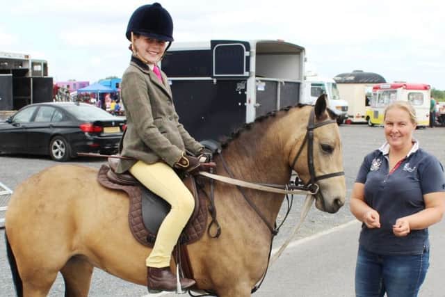Ready for the off at Saintfield Show: Sadie McMahon, from Markethill, on her show pony Lola in the company of her mum Sarah.