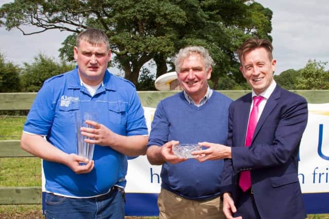William and James Crawford, Brookeborough, winners of the junior section's best heifer and best 70T cow awards, were congratulated by sponsor Simon Seaton, Ulster Bank. Picture: David Devennie Photography