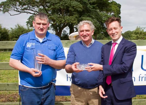 William and James Crawford, Brookeborough, winners of the junior section's best heifer and best 70T cow awards, were congratulated by sponsor Simon Seaton, Ulster Bank. Picture: David Devennie Photography