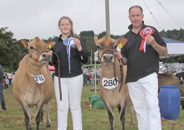 Ashley Fleming, and daughter Alisa, from Seaforde, with their champion and reserve interbreed dairy winners at Castlewellan Show.