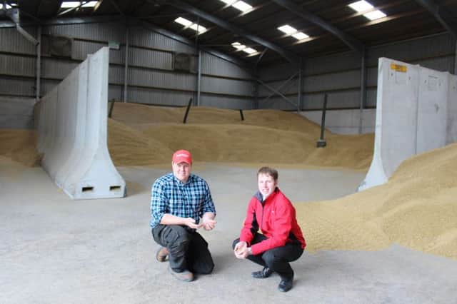 Seaforde Cereal grower Richard Kane (left) assessing the quality of this years winter barley with Moore Concretes Jeff Haslett. All the grain grown on the farm is dried and then moved to a bespoke 4,500t store, which features Moores versatile precast bunker wall system