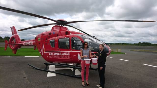 Belinda Hawthorne (Mid Down Group) and Kerry Anderson (Head of Funding with NI Air Ambulance) picking up the collection buckets for Castlewellan show.