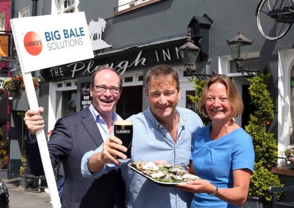 Derek Patterson, co-owner of The Plough Inn and Sarah Waugh, Hillsborough International Oyster Festival Committee alongside Philip Orr, Chief Executive of UPU Industries