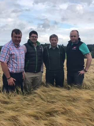 Pictured in the winning field of spring barley is Andrew Simpson, Alan Miller UFU Lagan Group Manager, Harry Simpson and Philip Simpson