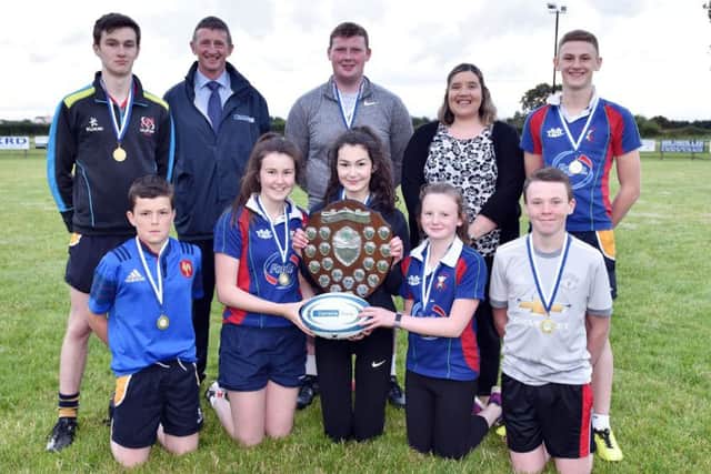 Members of Seskinore YFC with the Rosemary Cooper Shield after winning the junior title at the YFCU 2017 tag rugby tournament at Ballymoney RFC. The winning team are pictured with Robert McCullough, Danske BankÃ¢Â€Â™s head of agri business, and Carol McMullan, Danske BankÃ¢Â€Â™s agri-business manager, north