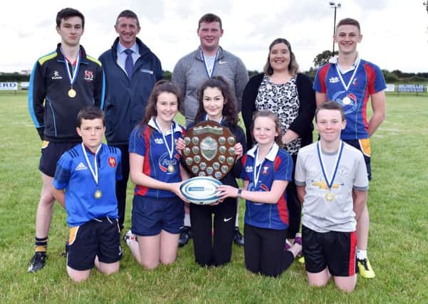 Members of Seskinore YFC with the Rosemary Cooper Shield after winning the junior title at the YFCU 2017 tag rugby tournament at Ballymoney RFC. The winning team are pictured with Robert McCullough, Danske BankÃ¢Â€Â™s head of agri business, and Carol McMullan, Danske BankÃ¢Â€Â™s agri-business manager, north