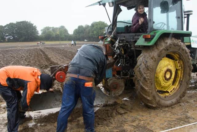 Evan McGirr and John McGrirr cleaning the plough for Tina McMenamin 
from  Killygordon at the National Ploughing Championship at Tullamore