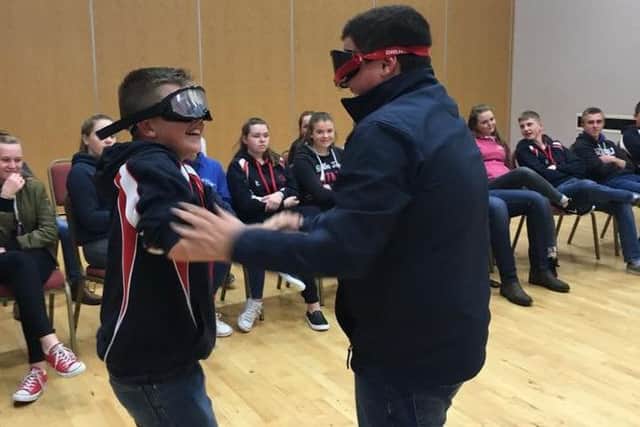 Two junior members try out the beer goggles and see the effect of alcohol