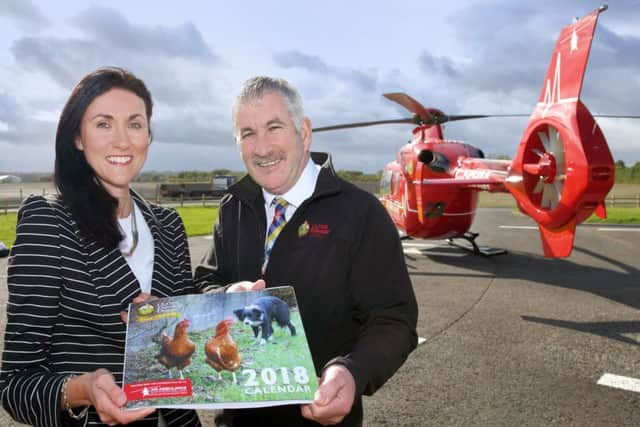 UFU deputy president, Victor Chestnutt, with AANI Head of Fundraising, Kerry Anderson, unveil the 2018 centenary calendar. Each calendar costs Â£10 with at least Â£5 going to AANI. UFU are aiming to raise Â£100,000 in its centenary year for the charity.