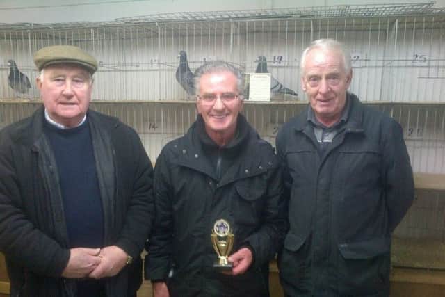 Ahoghill Old Cocks winner Victor Montgomery with the Kells judges Harry Boyd and Jeff Surgenor.